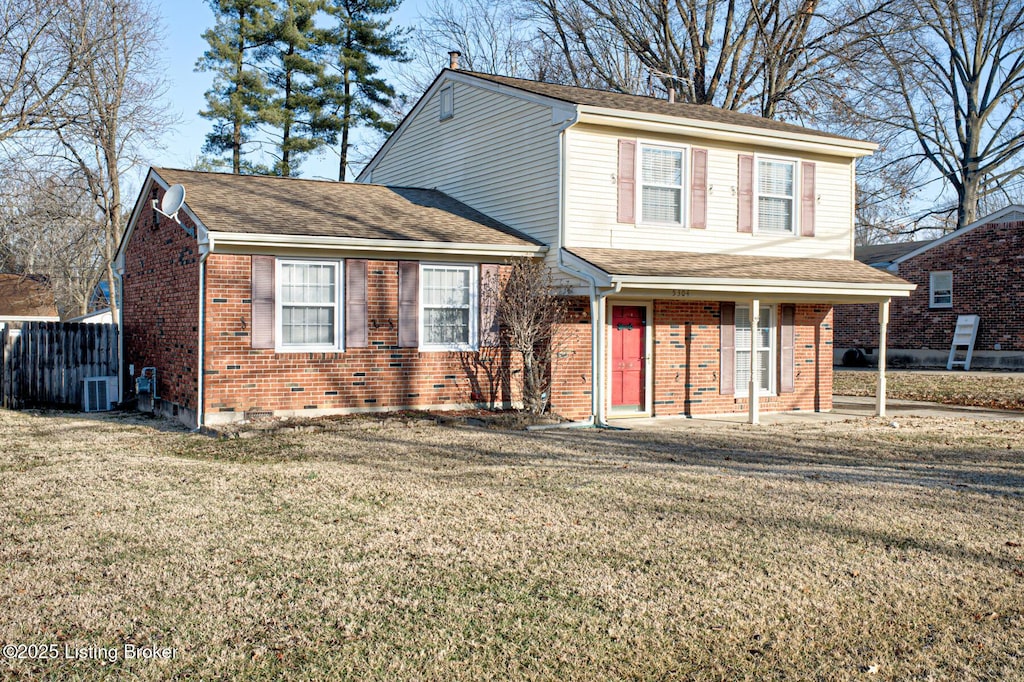 view of property featuring a front lawn and central air condition unit