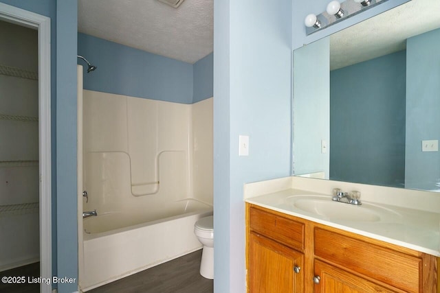 141-147 Darby Woods Ct, Radcliff, KY 40160 - full bathroom featuring wood-type flooring, shower / bath combination, vanity, toilet, and a textured ceiling