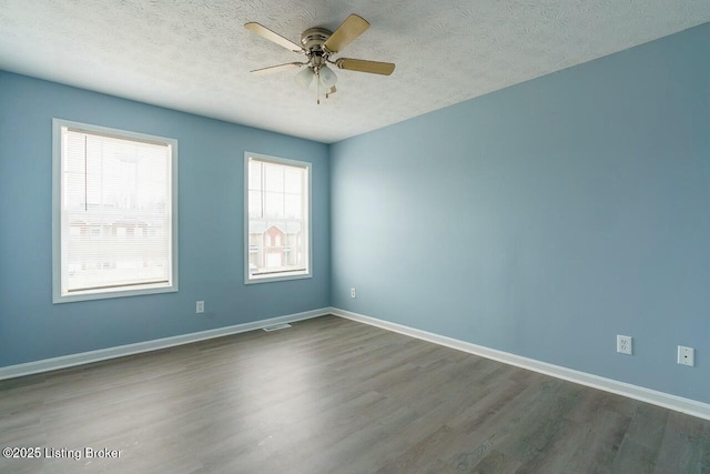 141-147 Darby Woods Ct, Radcliff, KY 40160 - empty room with dark wood-type flooring, ceiling fan, and a textured ceiling