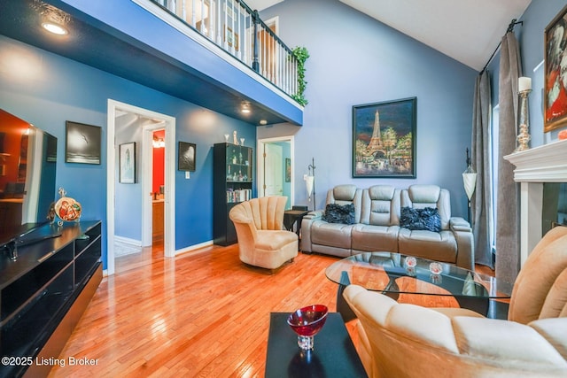 living room with high vaulted ceiling and hardwood / wood-style floors