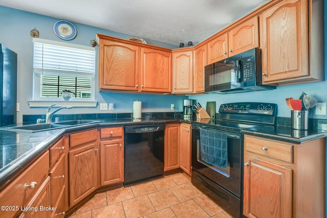 kitchen with sink, light tile patterned floors, a textured ceiling, and black appliances