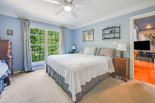 bedroom featuring crown molding, light carpet, and ceiling fan