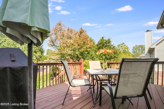 wooden deck with a grill