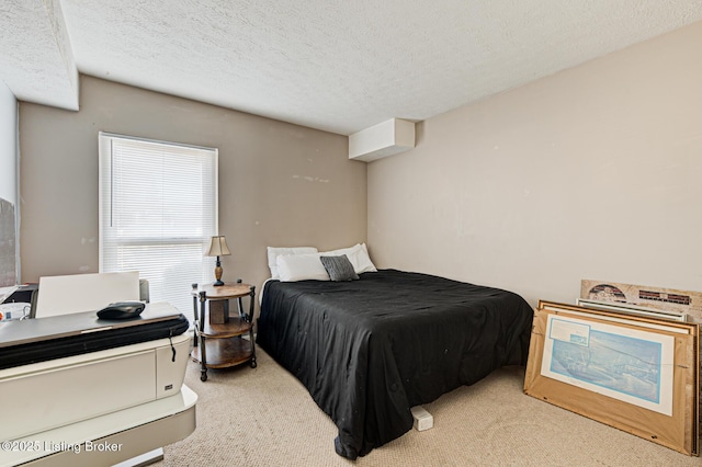 carpeted bedroom featuring a textured ceiling