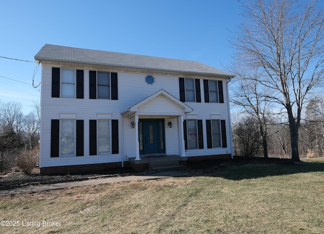 colonial-style house featuring a front yard