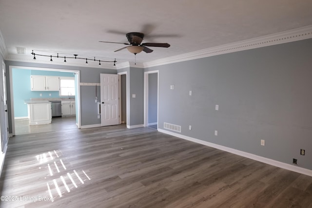 unfurnished living room with sink, ceiling fan, hardwood / wood-style floors, track lighting, and ornamental molding