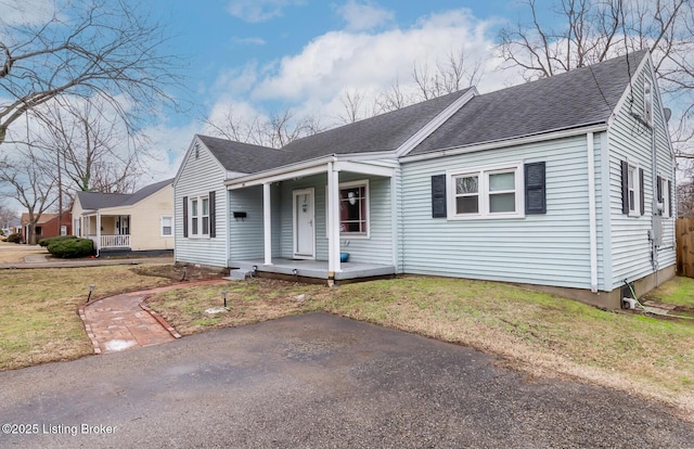 view of front facade with a front yard and a porch