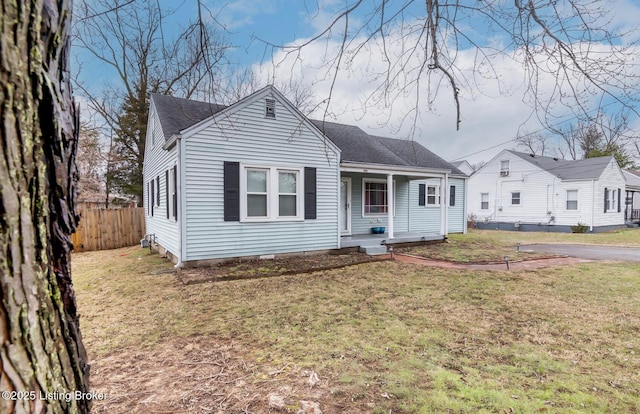 view of front of house with a front yard and a porch