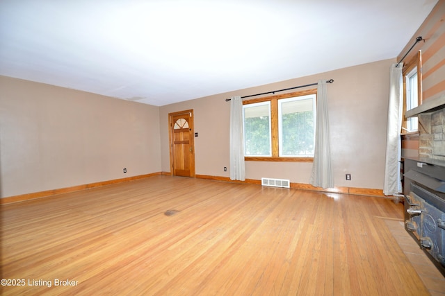 unfurnished living room featuring light hardwood / wood-style floors