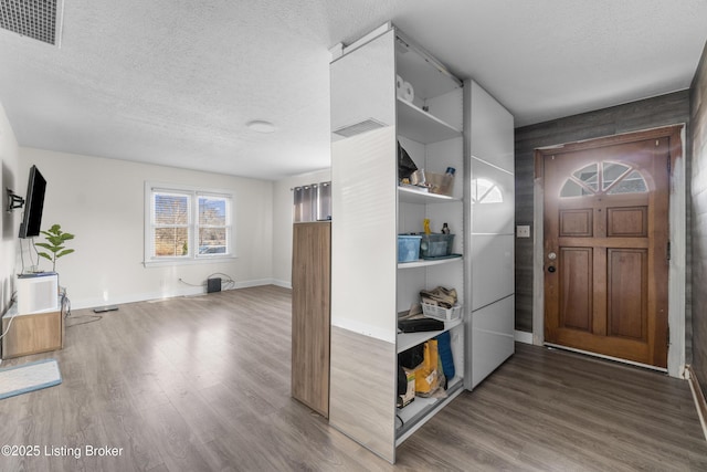 entrance foyer with hardwood / wood-style flooring and a textured ceiling