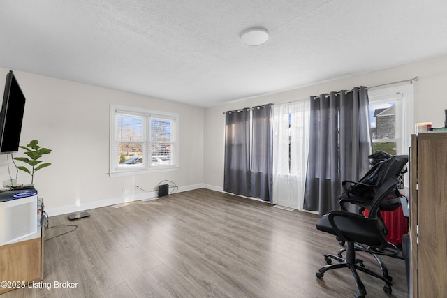 office space featuring wood-type flooring and a textured ceiling