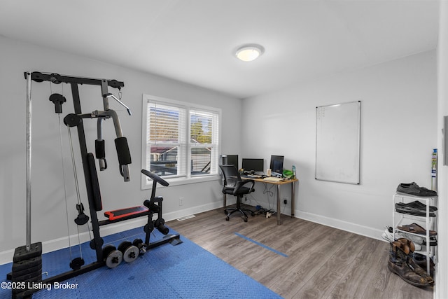 exercise area with wood-type flooring