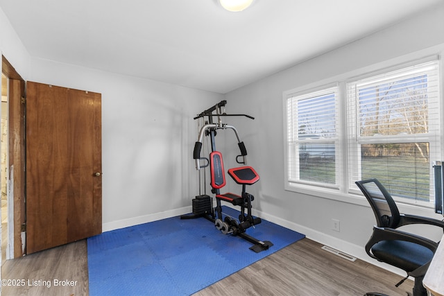 workout area with hardwood / wood-style flooring