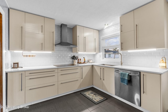 kitchen featuring wall chimney exhaust hood, dishwasher, sink, and cream cabinetry