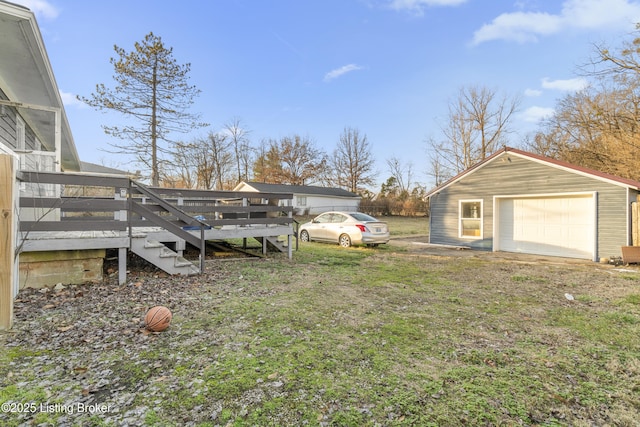 view of yard with a garage, an outdoor structure, and a deck