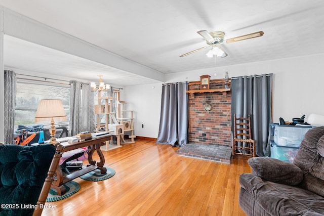 living room featuring hardwood / wood-style floors and ceiling fan with notable chandelier