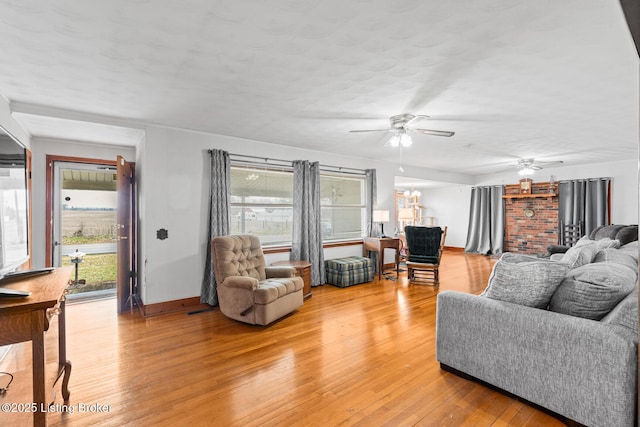 living room with hardwood / wood-style flooring, a wealth of natural light, a textured ceiling, and ceiling fan