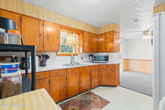 kitchen with ceiling fan and sink