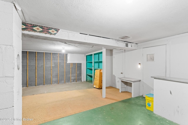 basement featuring a textured ceiling