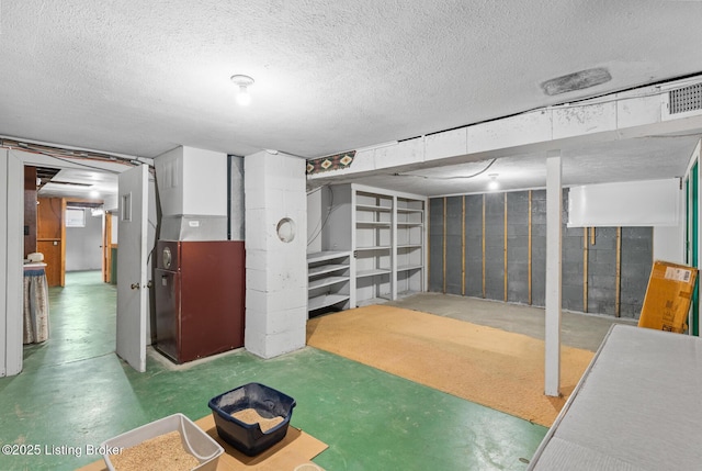 basement with heating unit and a textured ceiling