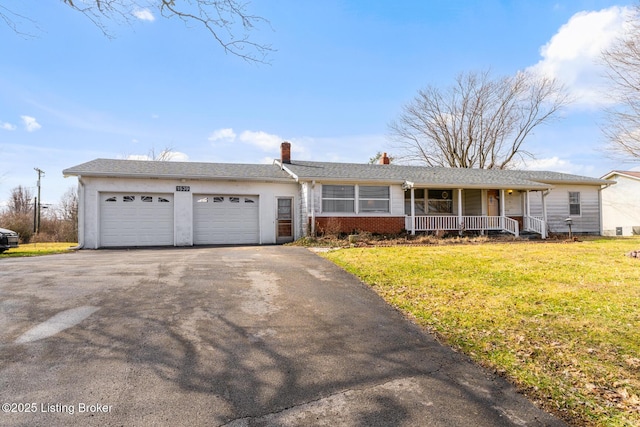 ranch-style home featuring a garage, covered porch, and a front lawn