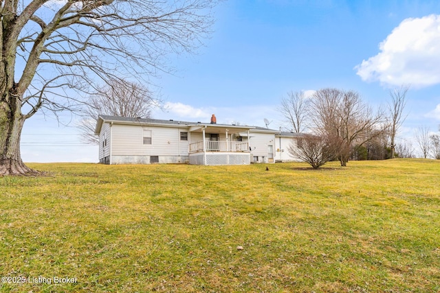 back of house with a yard and covered porch