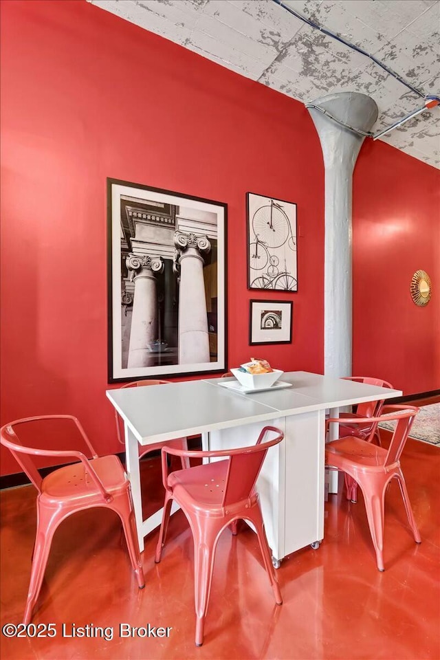 dining area featuring concrete flooring