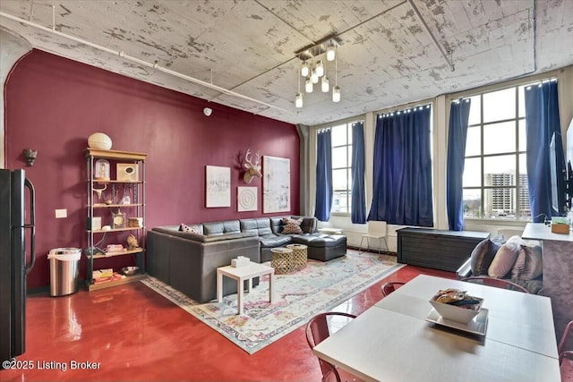 living room with plenty of natural light and concrete floors