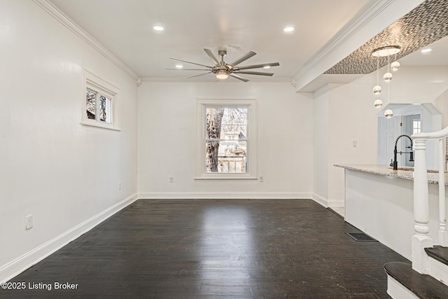 unfurnished living room featuring ceiling fan, ornamental molding, dark hardwood / wood-style floors, and sink