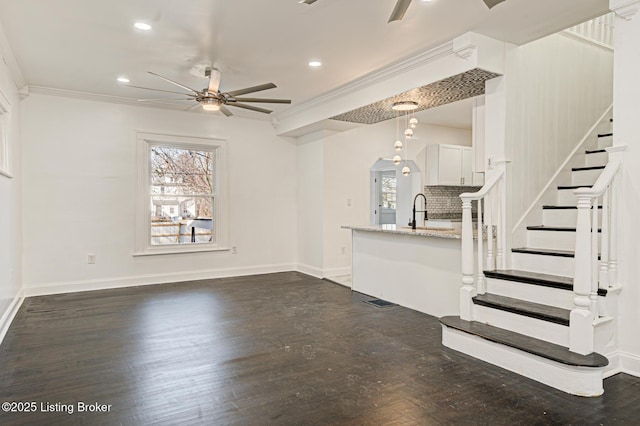 unfurnished living room with crown molding, dark hardwood / wood-style floors, and ceiling fan