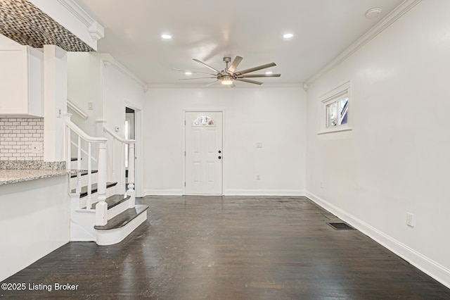 foyer entrance featuring dark hardwood / wood-style flooring, crown molding, and ceiling fan