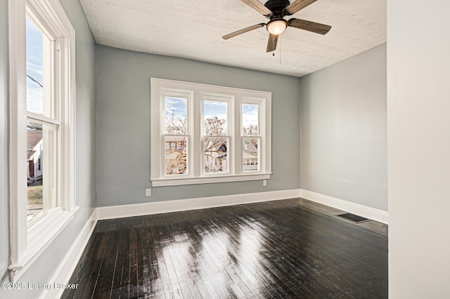 unfurnished room with ceiling fan, dark hardwood / wood-style flooring, and a textured ceiling