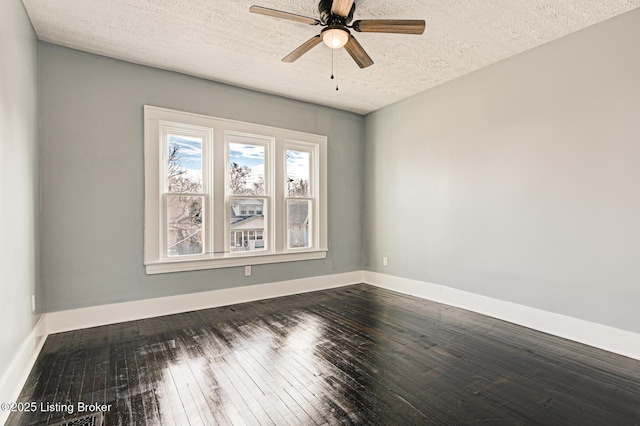 spare room with ceiling fan, dark hardwood / wood-style floors, and a textured ceiling