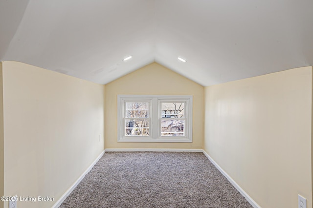 empty room with lofted ceiling and carpet