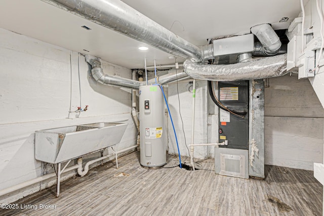 utility room featuring sink and water heater