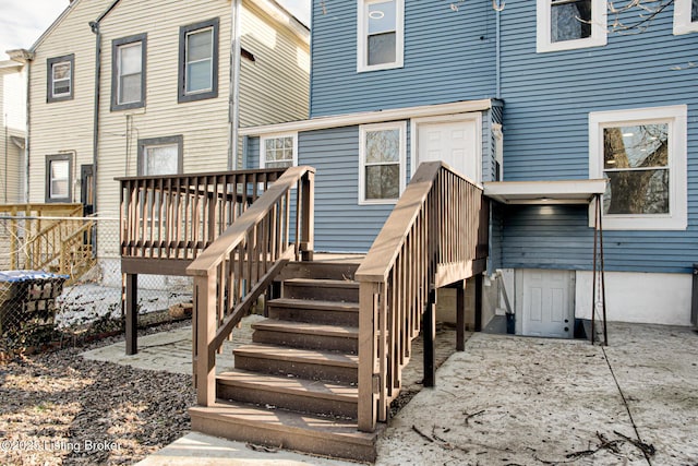 back of house featuring a wooden deck