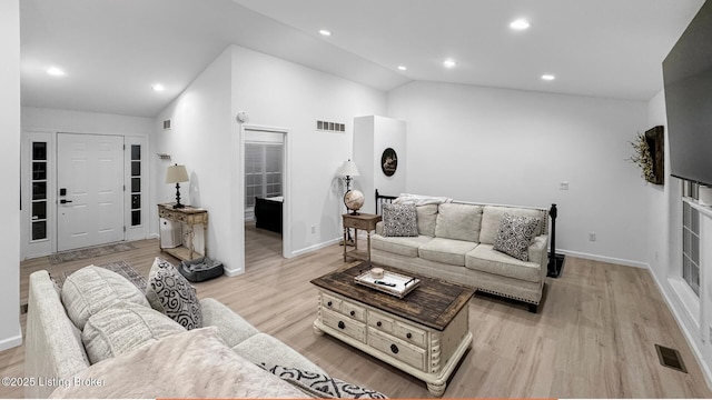 living room featuring vaulted ceiling and light hardwood / wood-style floors