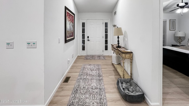 hallway with light hardwood / wood-style flooring