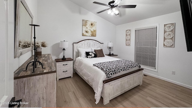 bedroom featuring vaulted ceiling, ceiling fan, and light hardwood / wood-style flooring