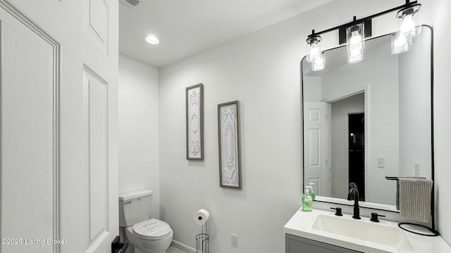 bathroom with vanity and toilet