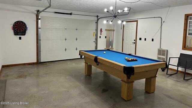 recreation room featuring billiards, concrete floors, and a textured ceiling