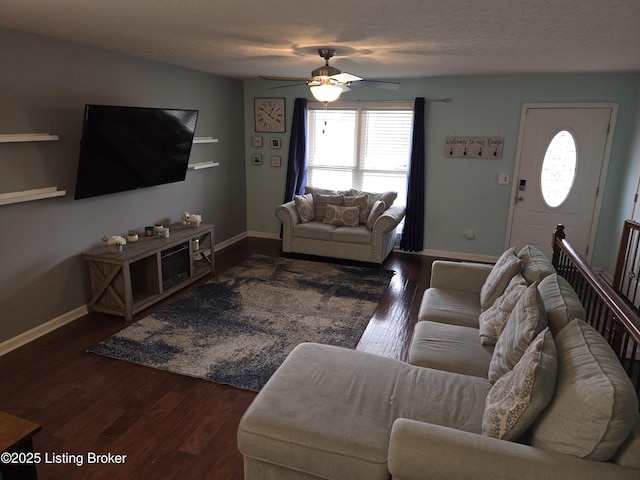 living room featuring ceiling fan, dark hardwood / wood-style floors, a textured ceiling, and a wealth of natural light