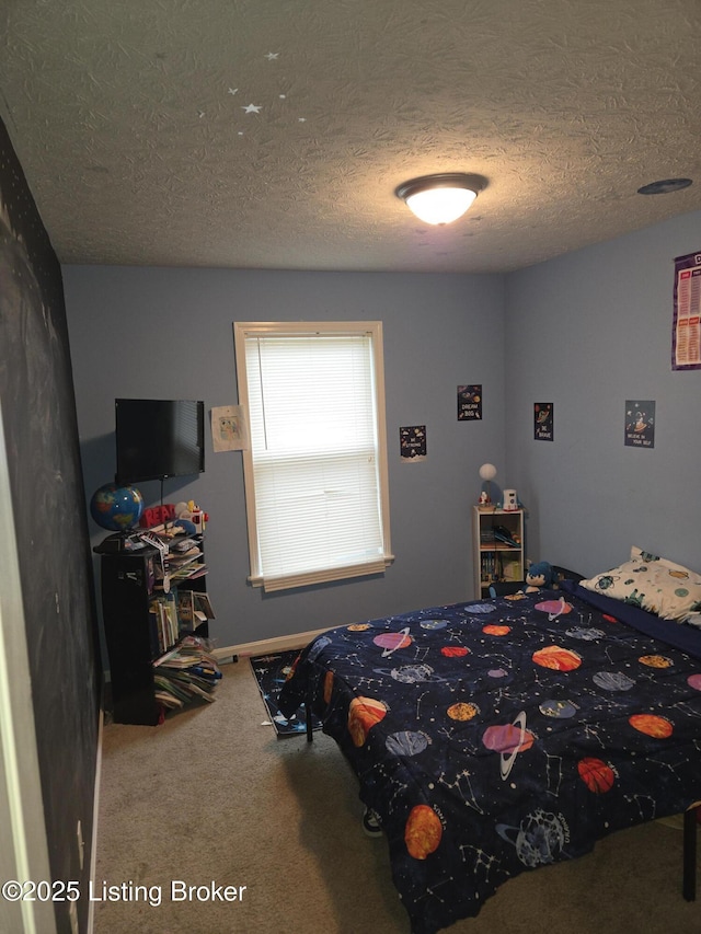 carpeted bedroom featuring a textured ceiling