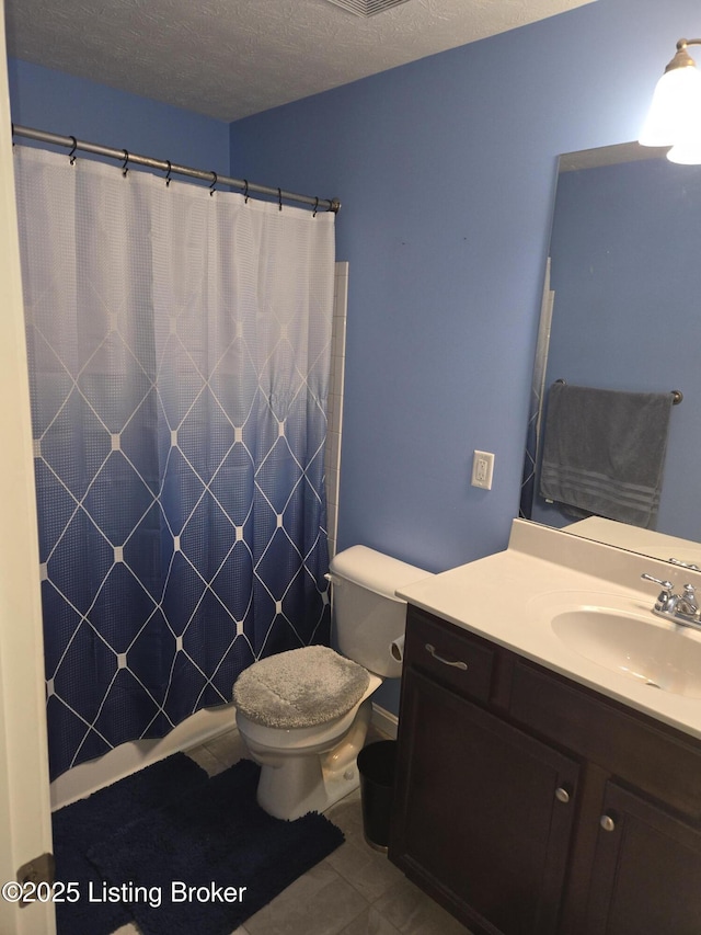 bathroom featuring toilet, a textured ceiling, vanity, a shower with shower curtain, and tile patterned flooring