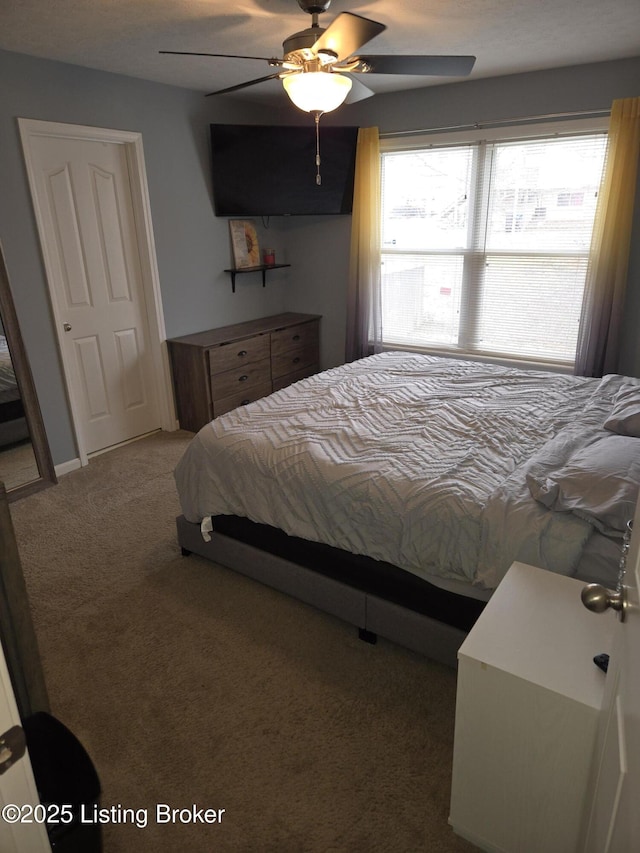 carpeted bedroom featuring ceiling fan