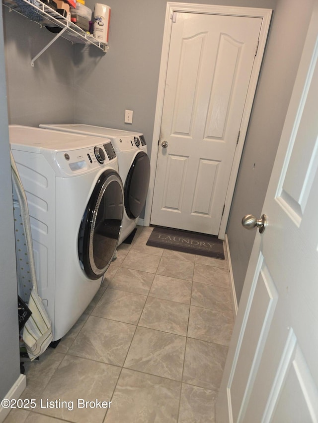 washroom featuring washer and dryer and light tile patterned floors