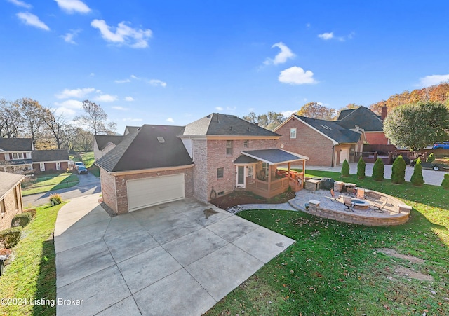 exterior space with a front lawn and a fire pit