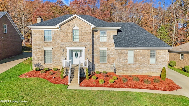 view of front of property featuring central AC and a front lawn