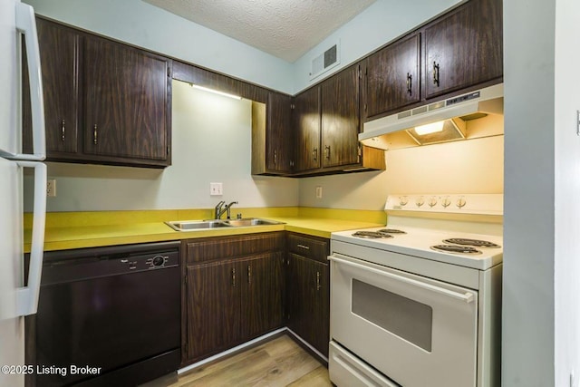 kitchen featuring a textured ceiling, under cabinet range hood, a sink, electric stove, and dishwasher