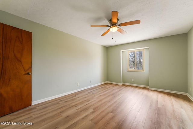 unfurnished room featuring a ceiling fan, a textured ceiling, baseboards, and wood finished floors